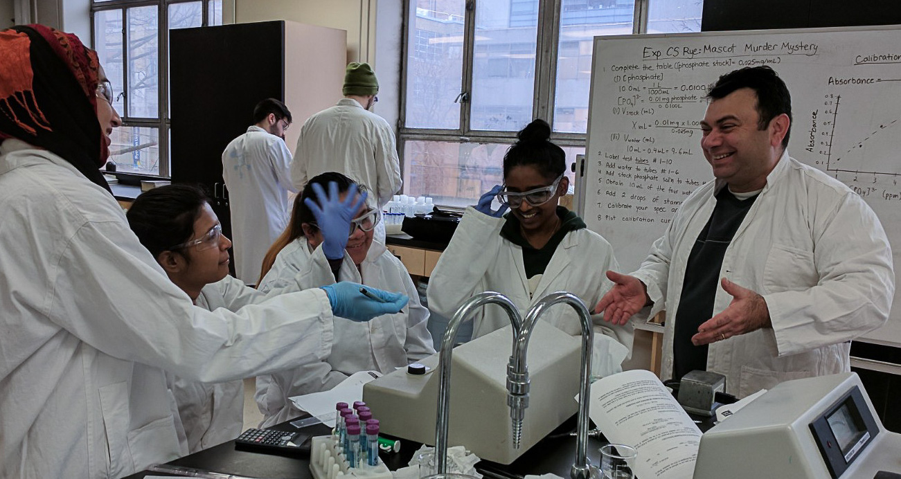Four students and one instructor using a spectrometer in the lab.