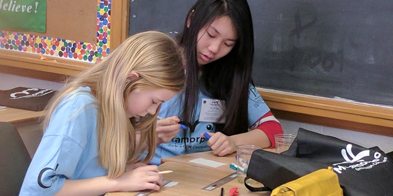 2 young girls working on experiment