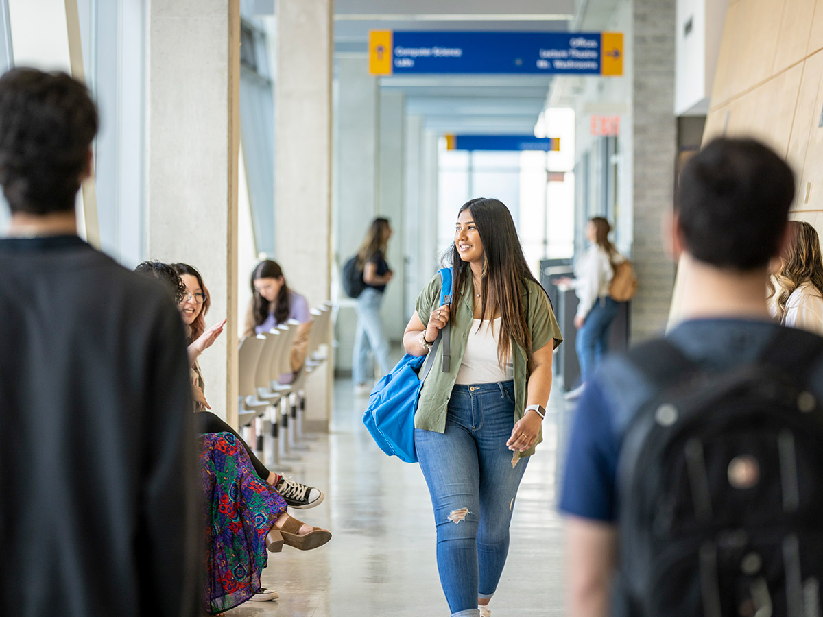 TMU student walking in hallway in spring