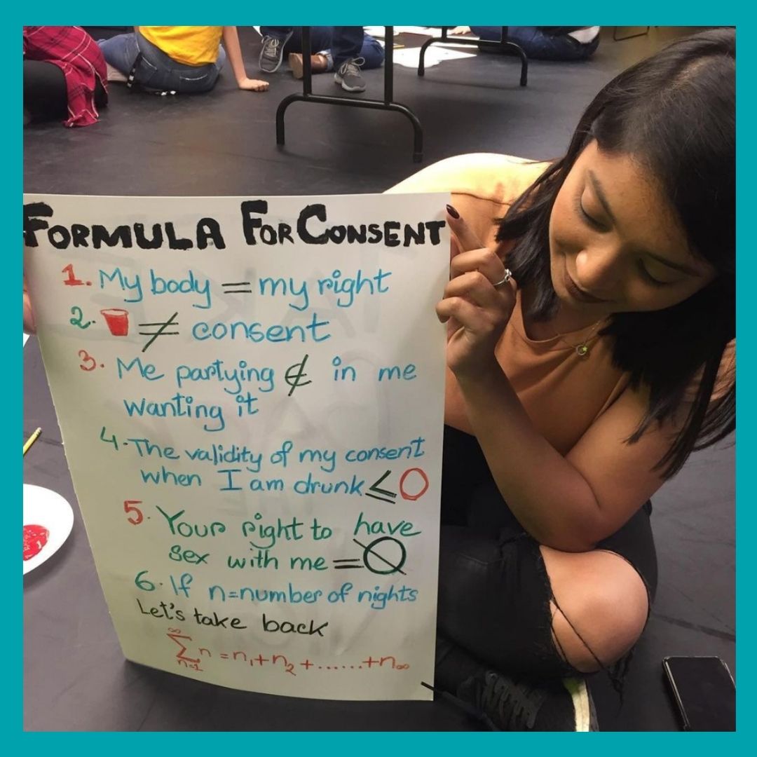 A girl holding a sign saying "formula for consent".
