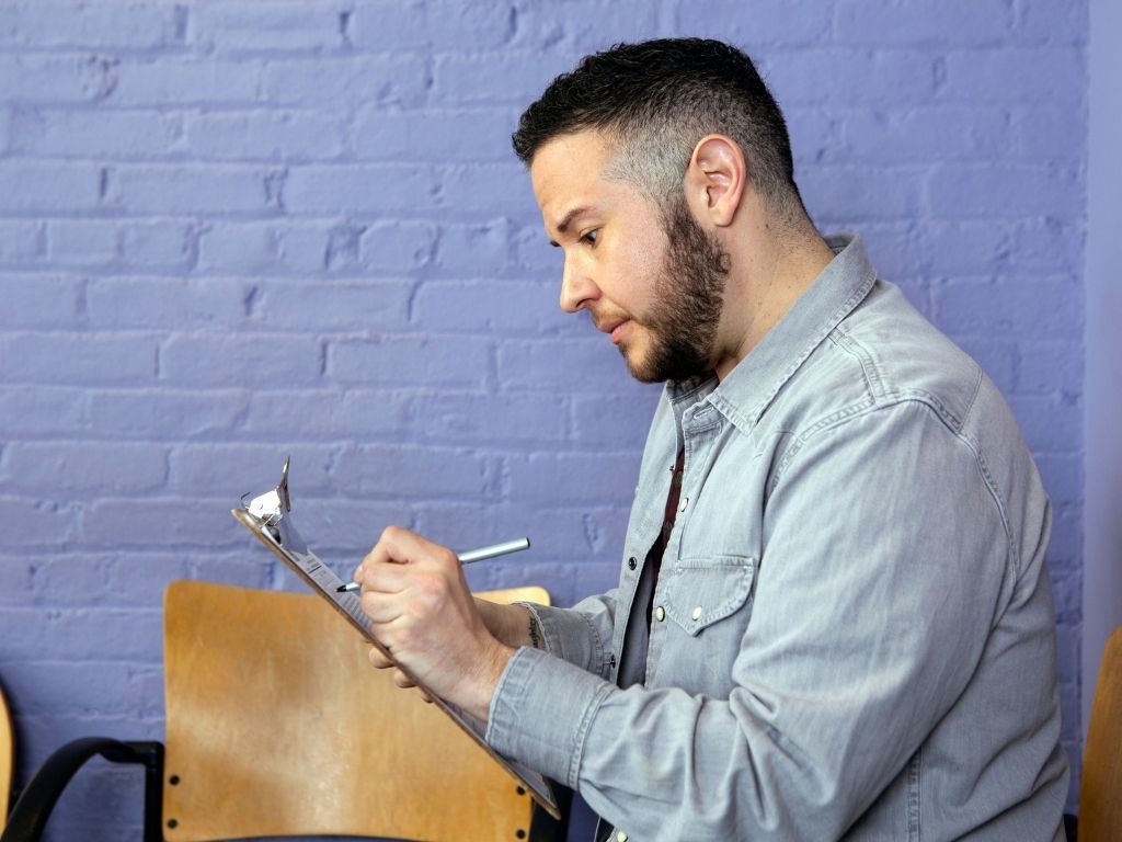 A transgender man filling out paperwork