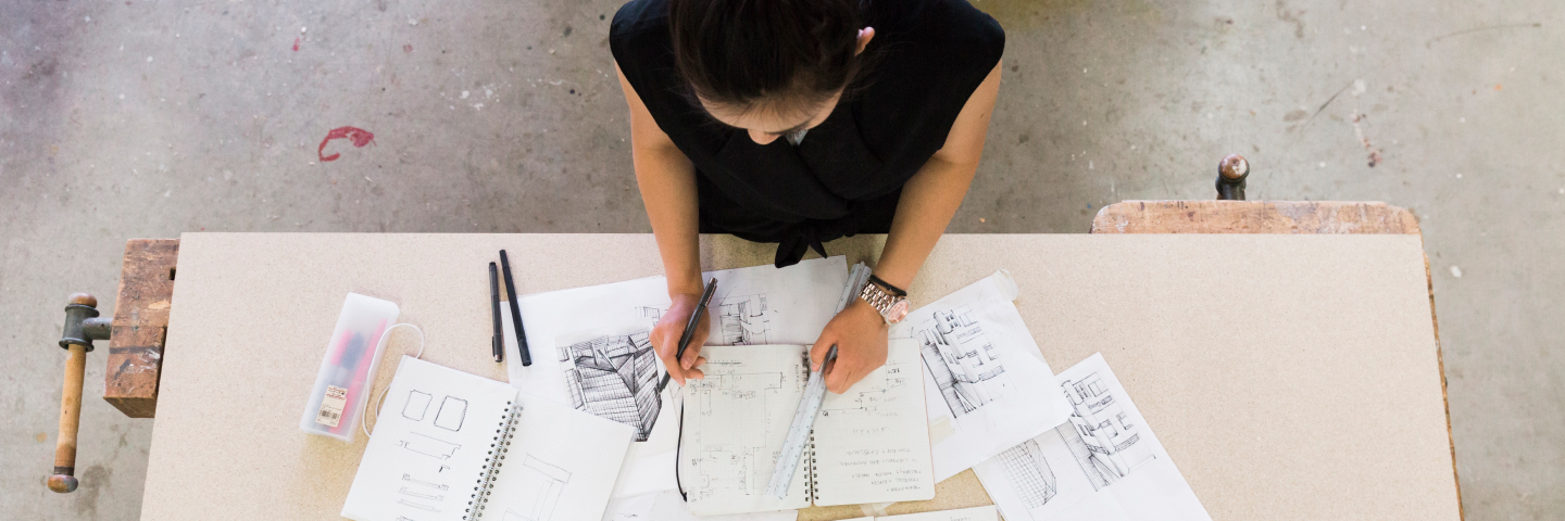 Sketchbook and pieces of materials on a study table