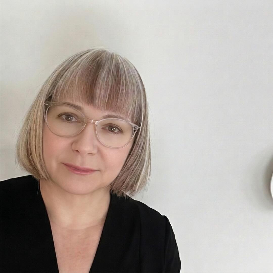 Man smiling with his hands folded.