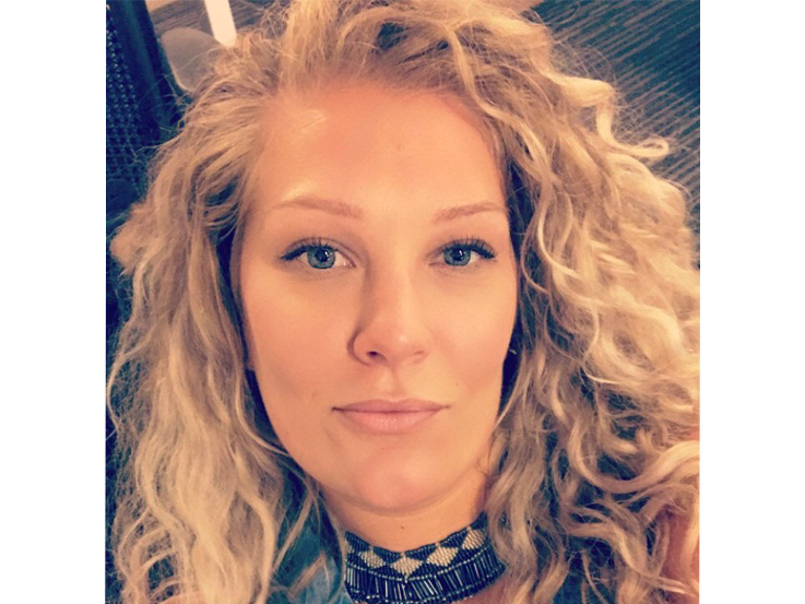 Image of Jessica Griffiths, woman smiling with shoulder-length curly hair