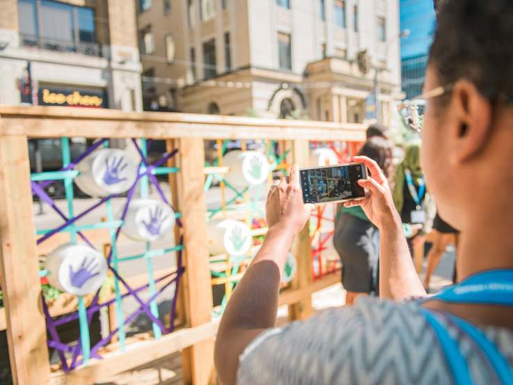 An individual photographing the ShapeLab installation.