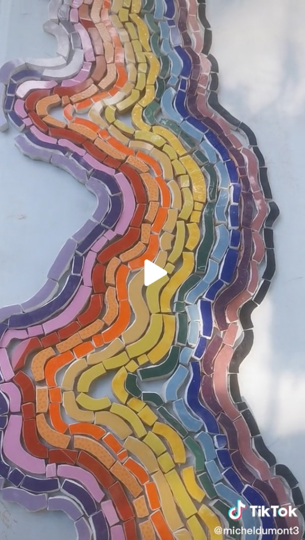 Rainbow mosaic pieces in the shape of a river.