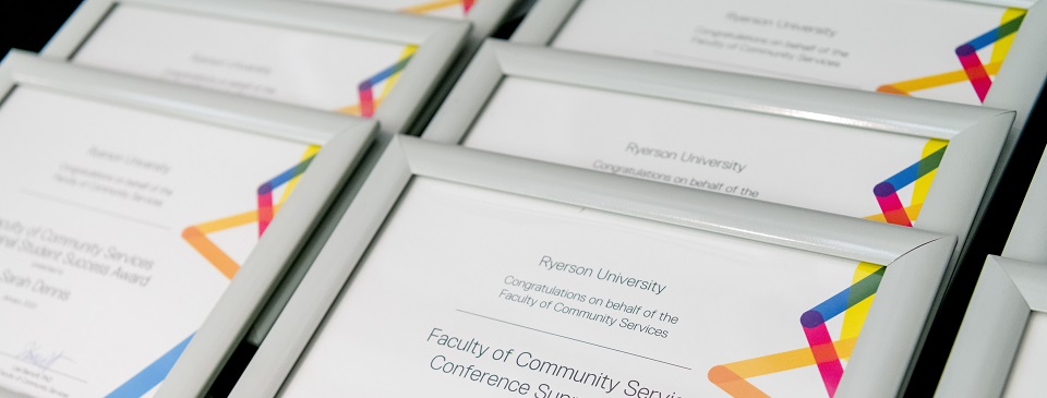 Award certificates stacked on a table