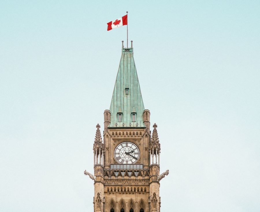 the tower of the Canadian parliament building, with a flag flying on top