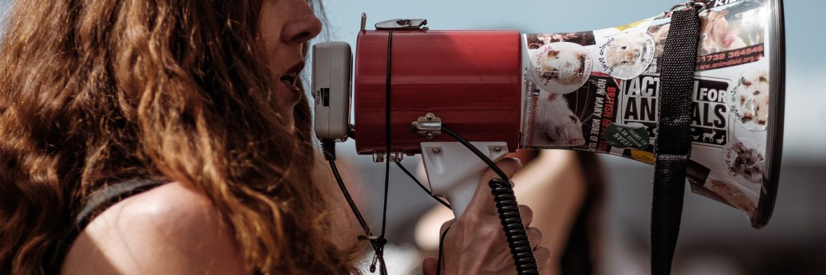 a close-up of a woman holding a megaphone