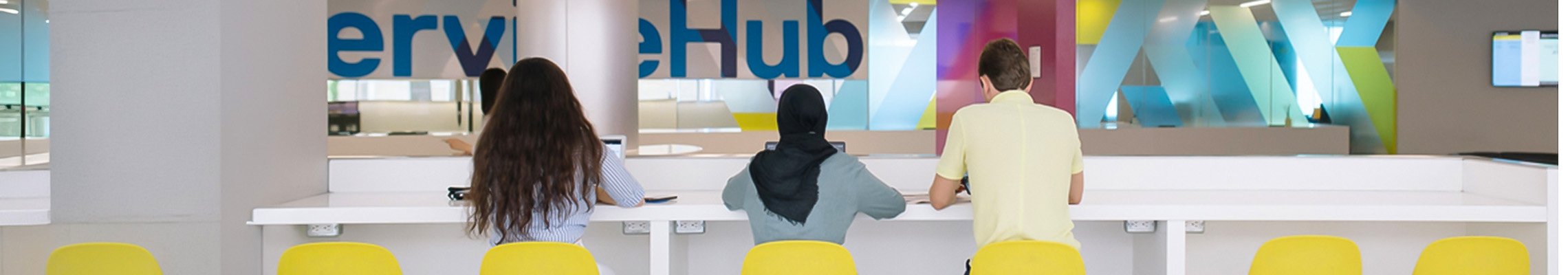 Students sitting on stools in ServiceHub