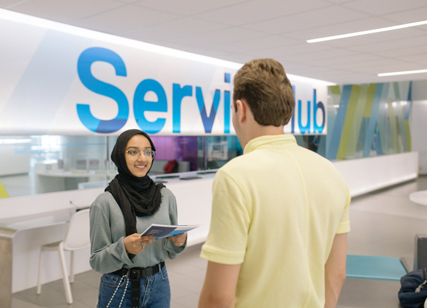 ServiceHub staff member speaking to a student