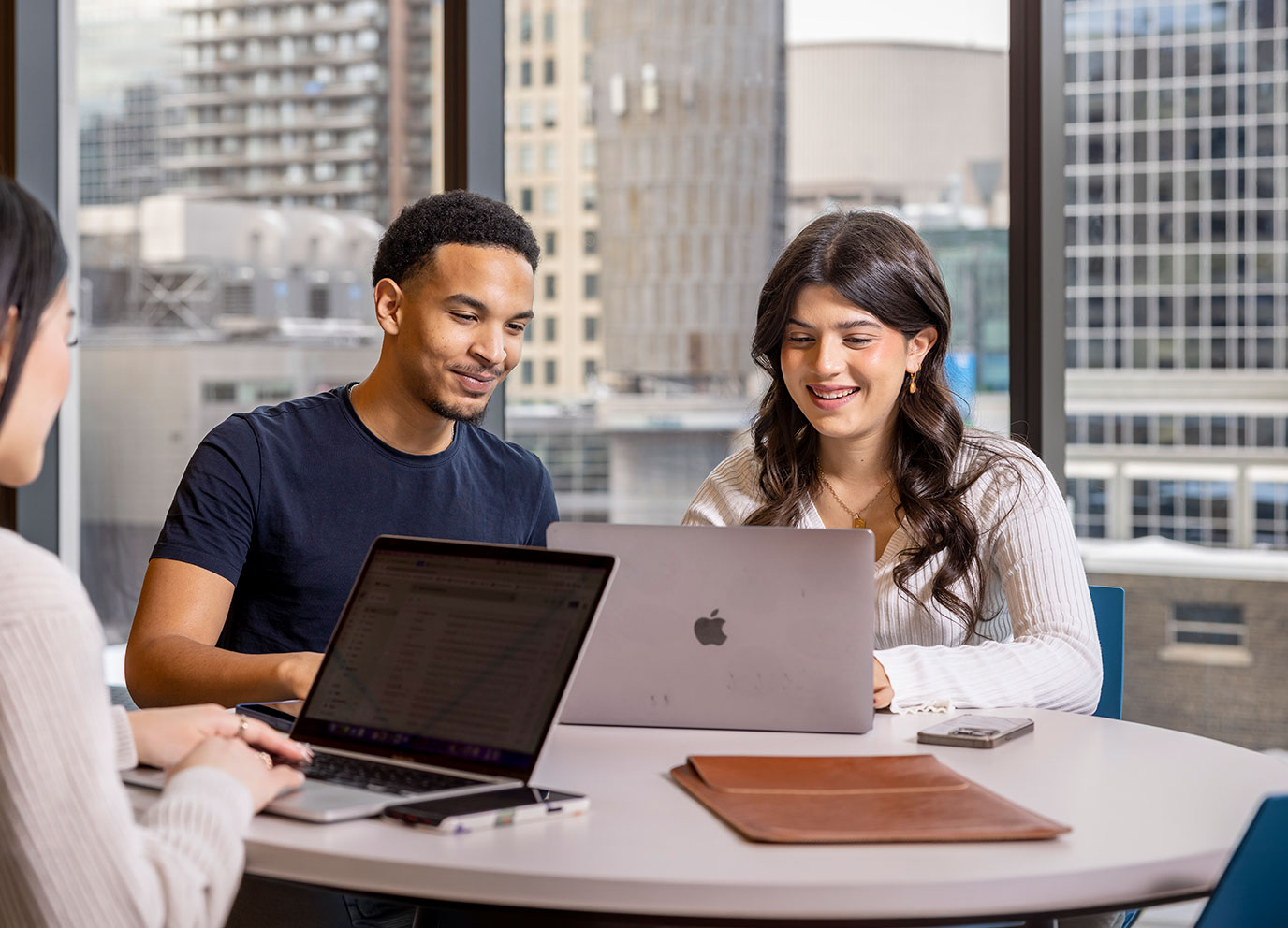 Two students working together on a laptop