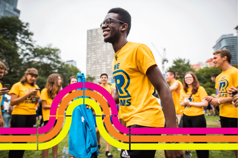 Student smiling with group of students in the Ryerson Quad during orientation