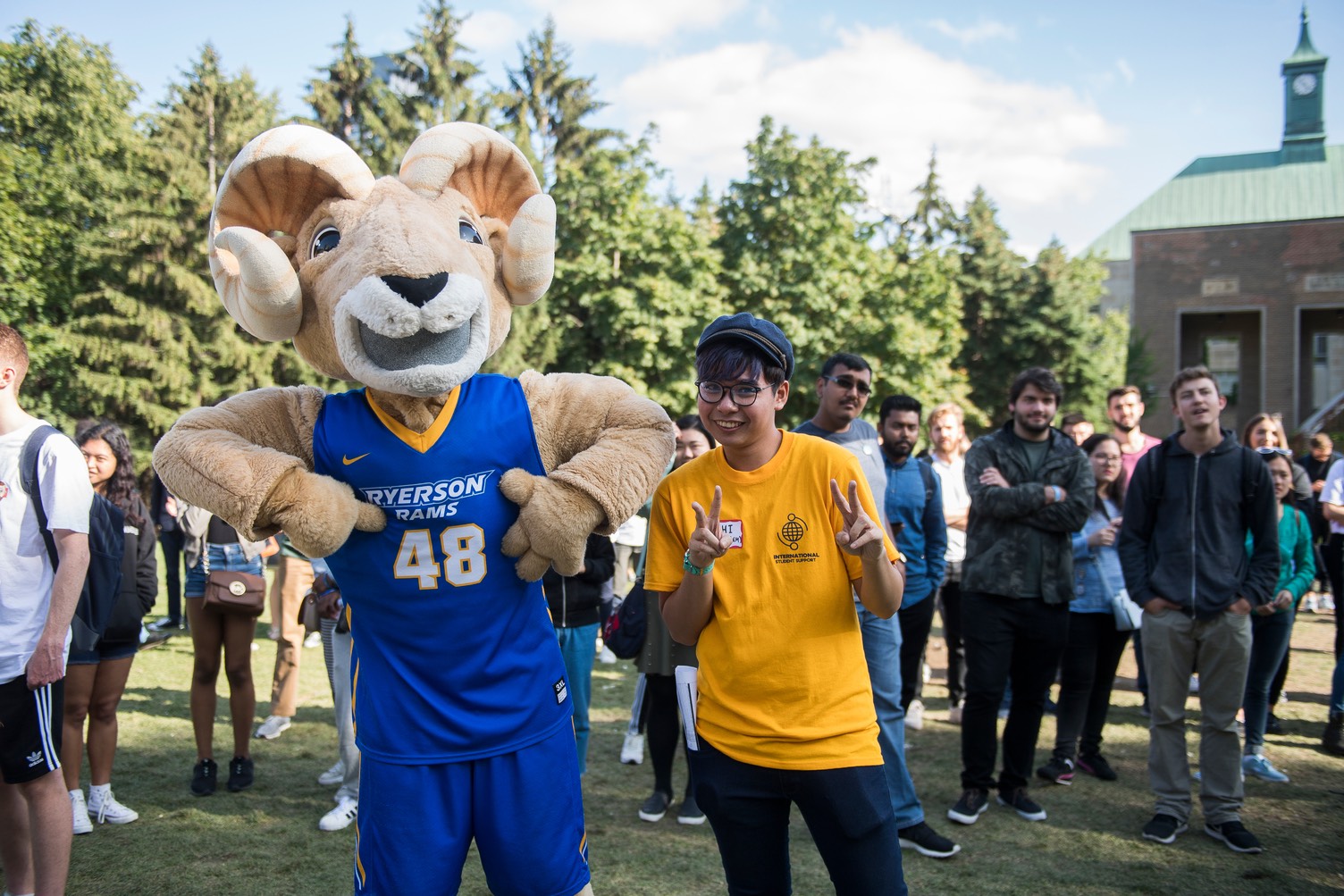 Student leader from International Student Support with mascot at orientations.