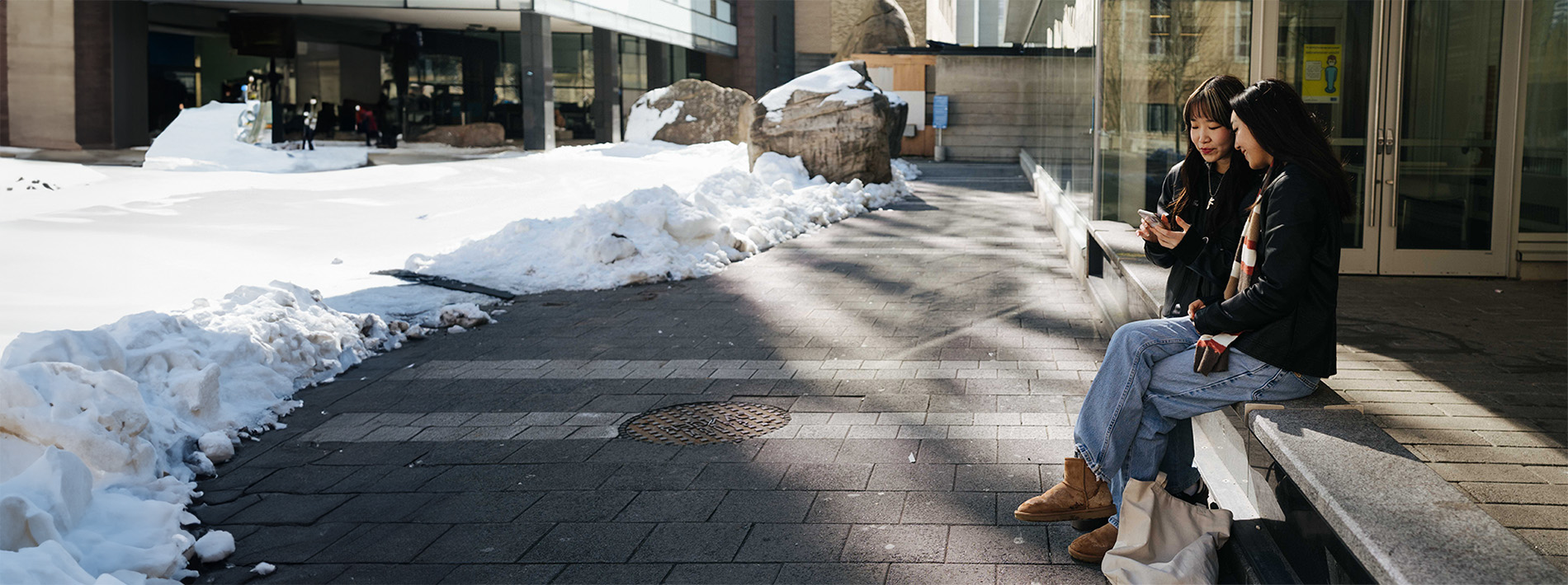 Students hanging out by Lake Devo in the winter.