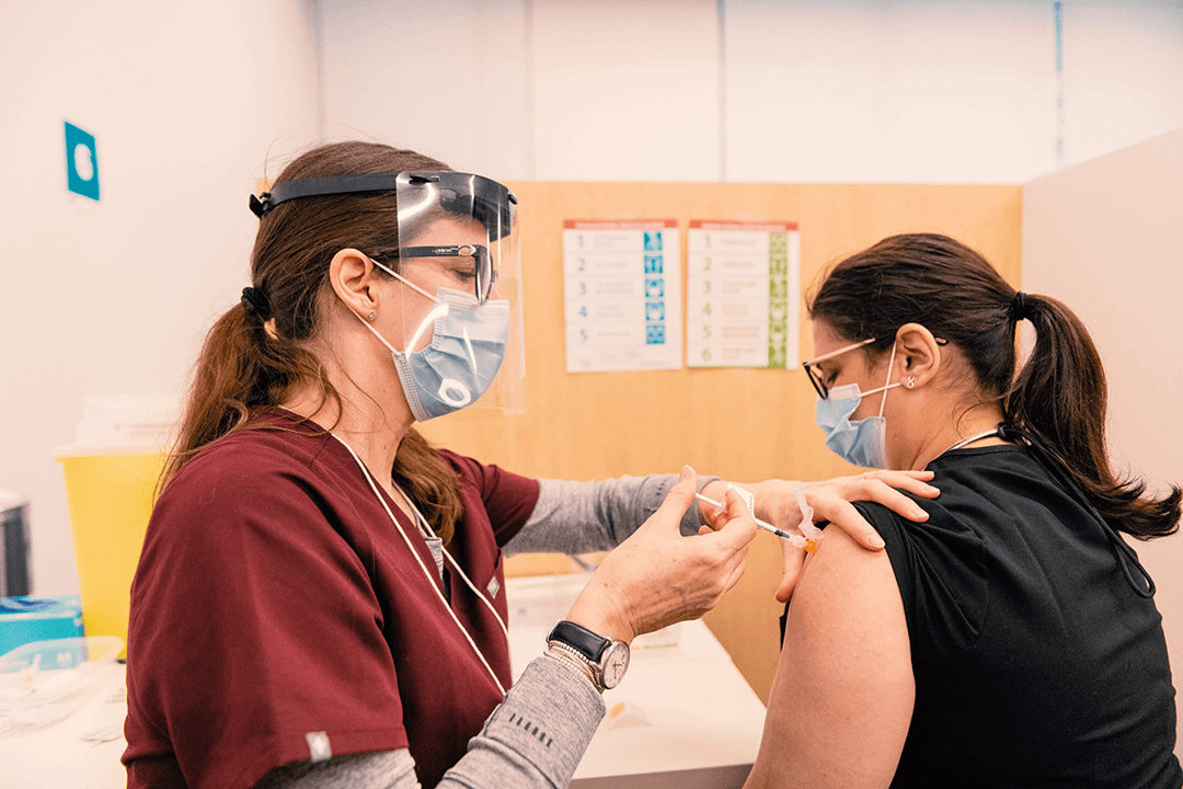 A woman receiving her COVID-19 vaccination