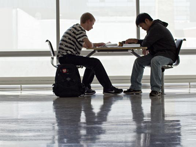 Two students studying at a table.