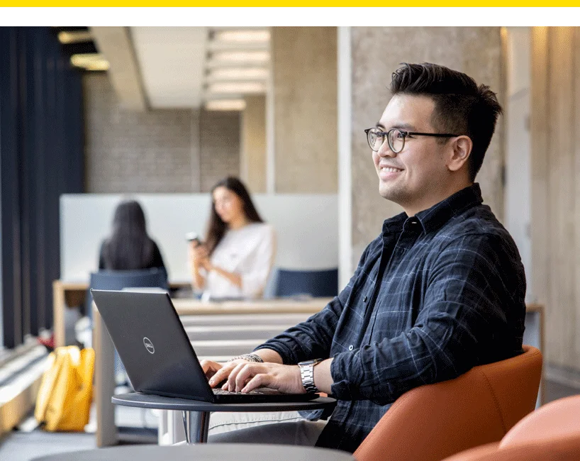 a student sitting with a laptop