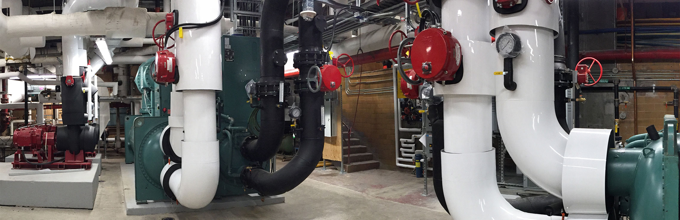 Large steam pipes in the basement of a building on campus.
