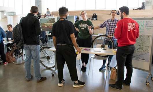 Two volunteers doing educational outreach about the benefits of cycling.