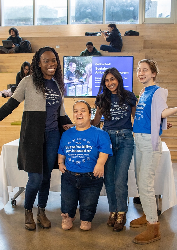 Members of the sustainability team candidly smiling for a group photo during an engagement event. 