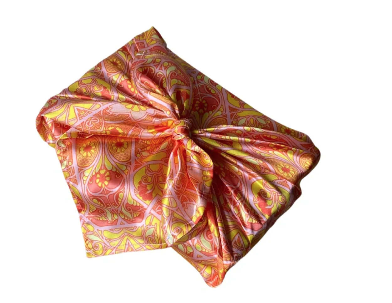 Gift wrapped in reusable orange, pink and yellow cloth