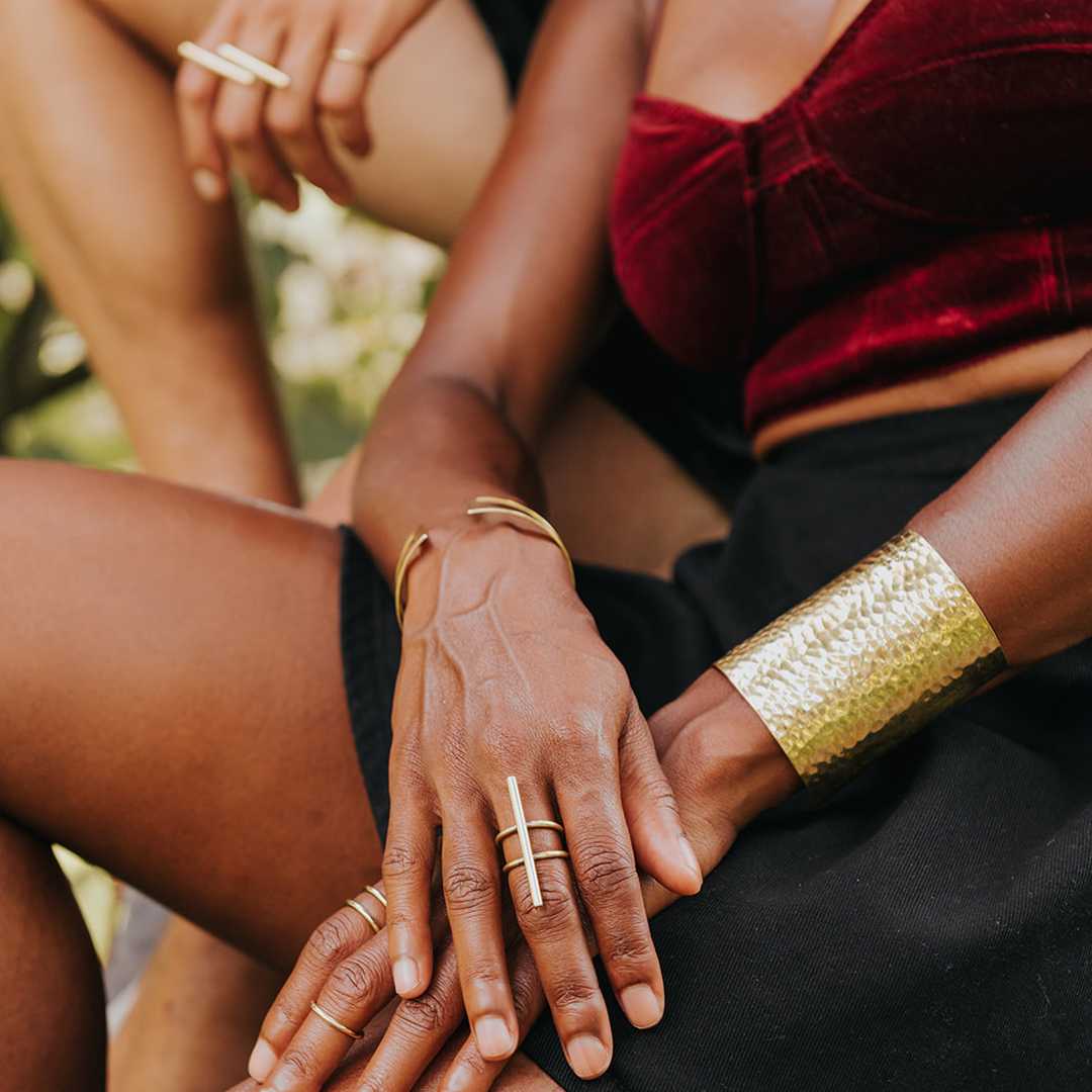 closeup of two women's hands wearing rings and cuff bracelet by Chic Made Consciously
