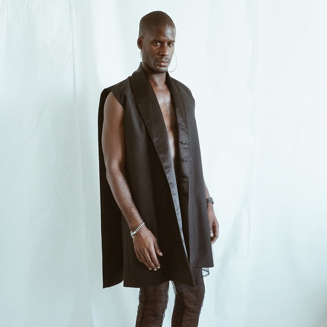 Luomo Strano Founder Mic Carter modeling long black vest
