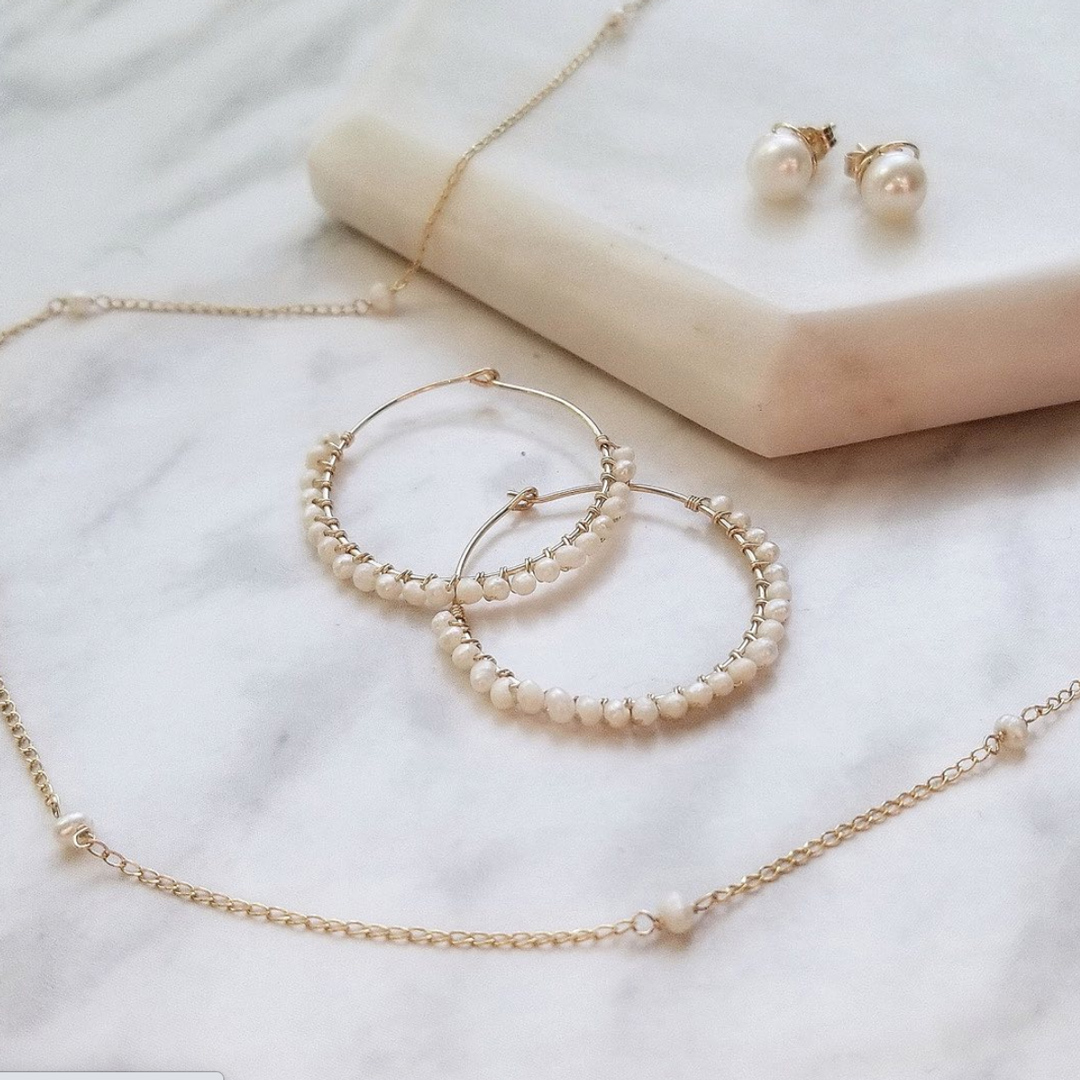 collection of Kind Karma necklace and pearl earrings