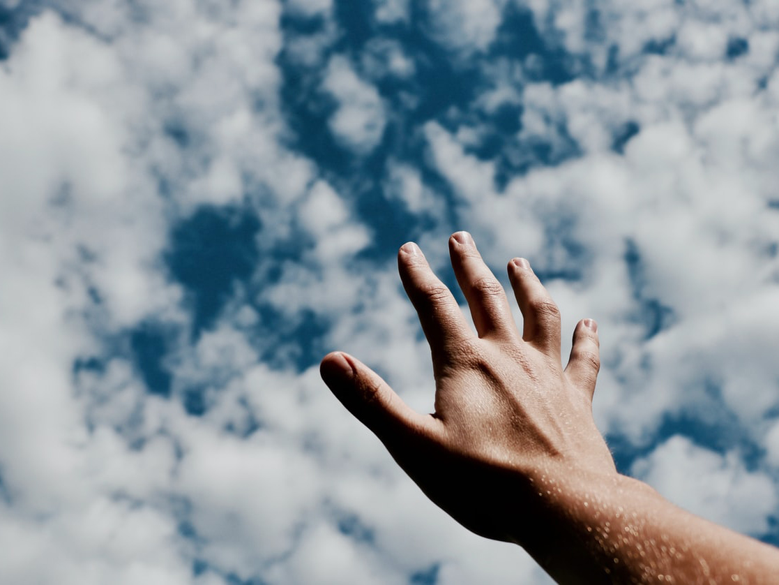 hand reaching out to sky