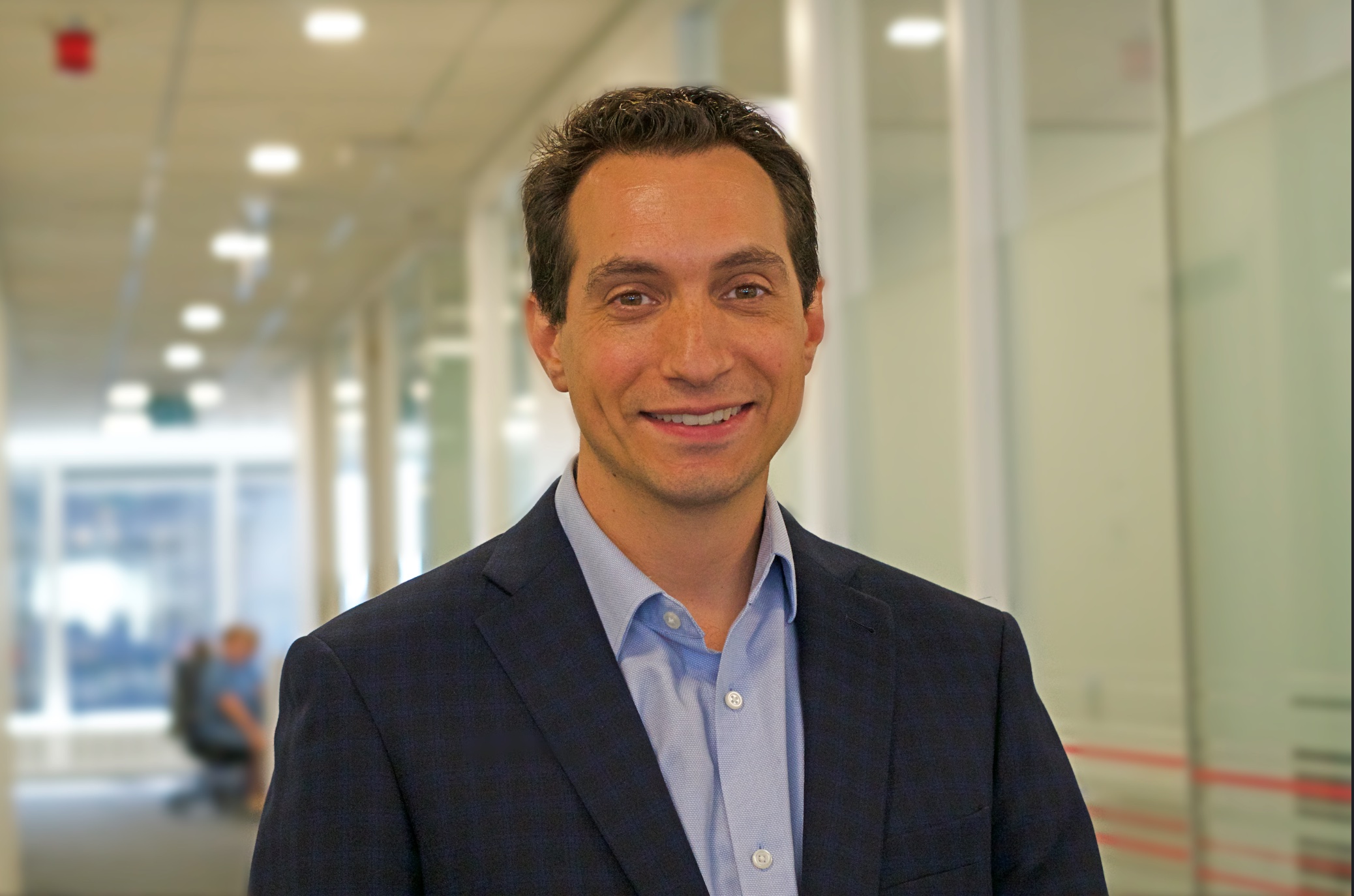 Image of man wearing a suit smiling 