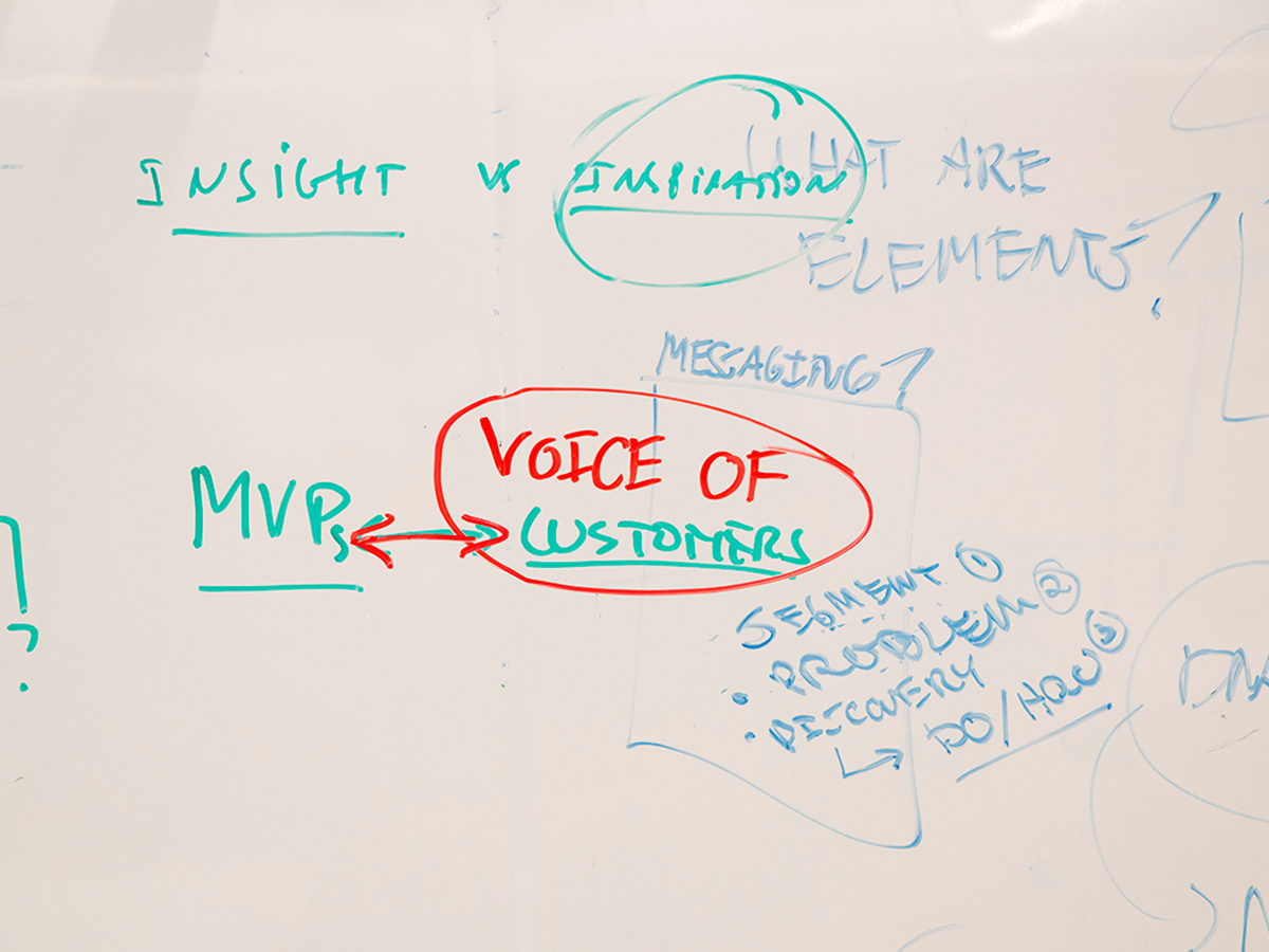 White board with notes on brainstorming ideas for a minimum viable product