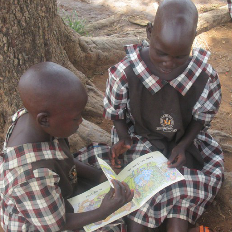 two female students reading a book