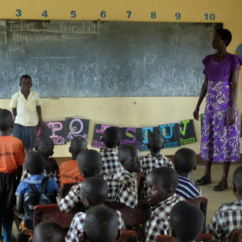 teacher and student in front of classroom