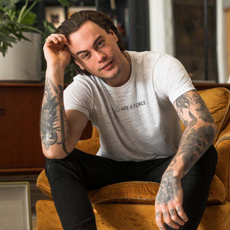 man wearing a tshirt and smiling at the camera