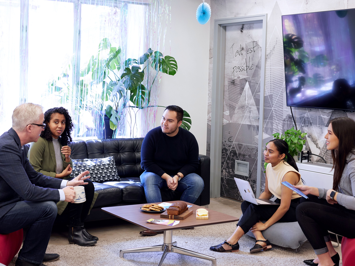 entrepreneurs sitting down in the Social Ventures Zone space, chatting with the SVZ director