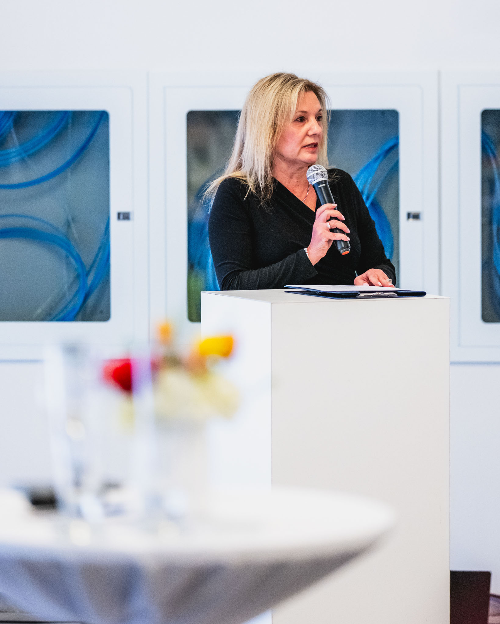 Image of woman speaking into a microphone