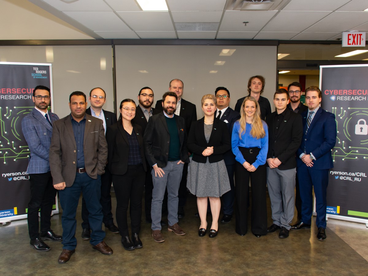 CRL Researchers wearing business formal clothes, posing for a group photo.