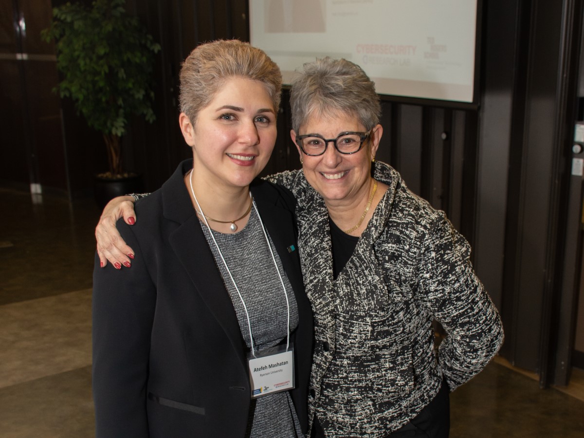 CRL director's Atefeh Mashatan and Dean of TRSM, Dr. Daphne Taras, smiling for the camera.