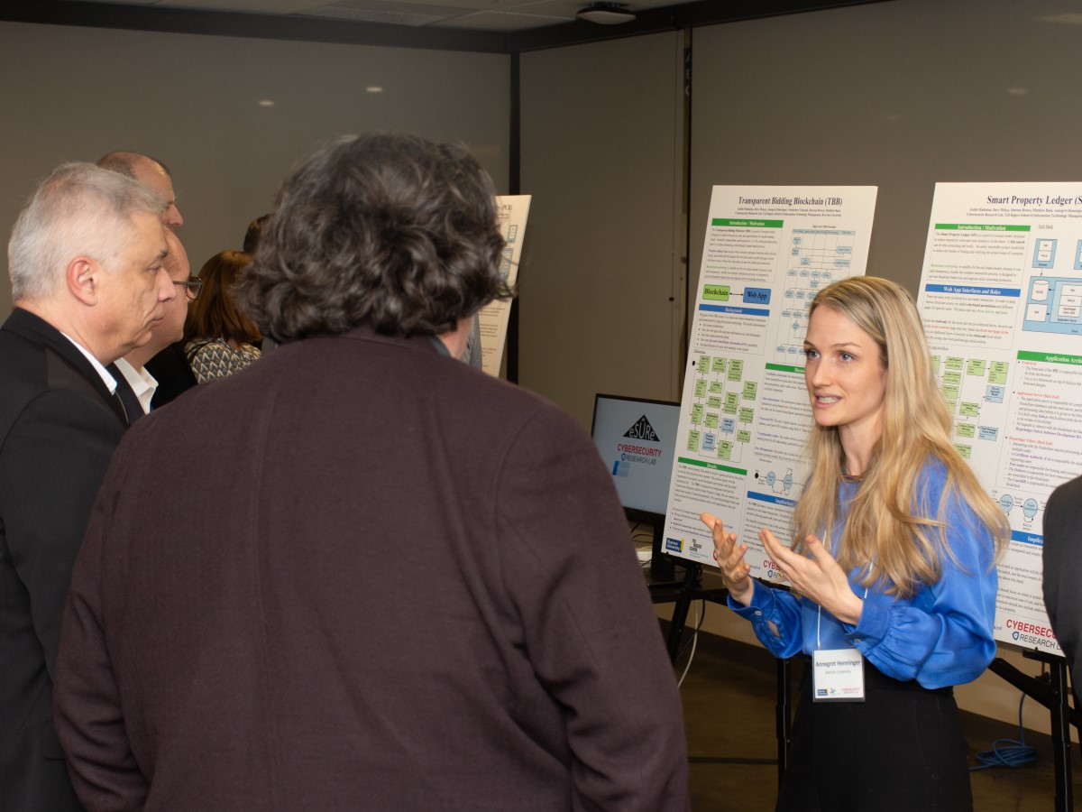 CRL Research Assistant Annegret Henninger, standing in front of a research poster explaining her diagrams.