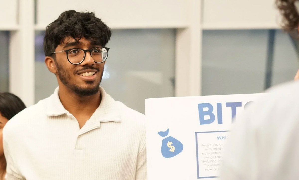 Student from Enactus with a board to showcase BITS 