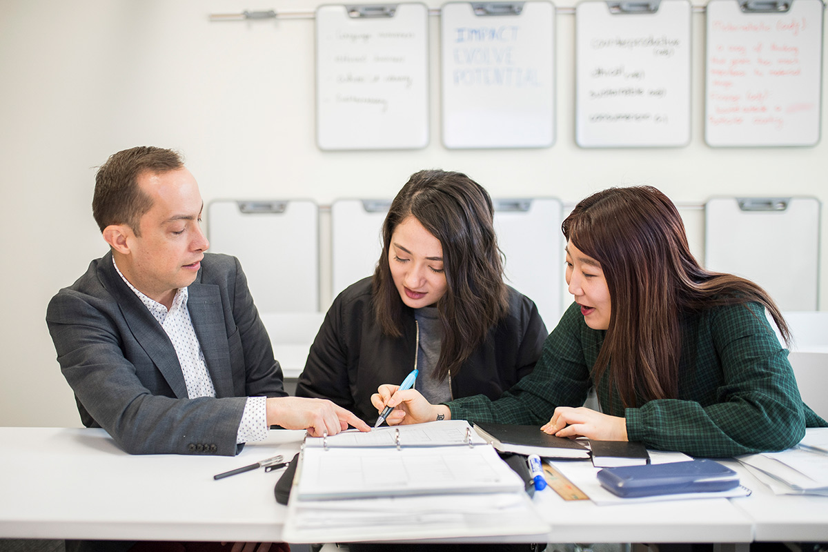 students gardening on campus rooftop urban farm