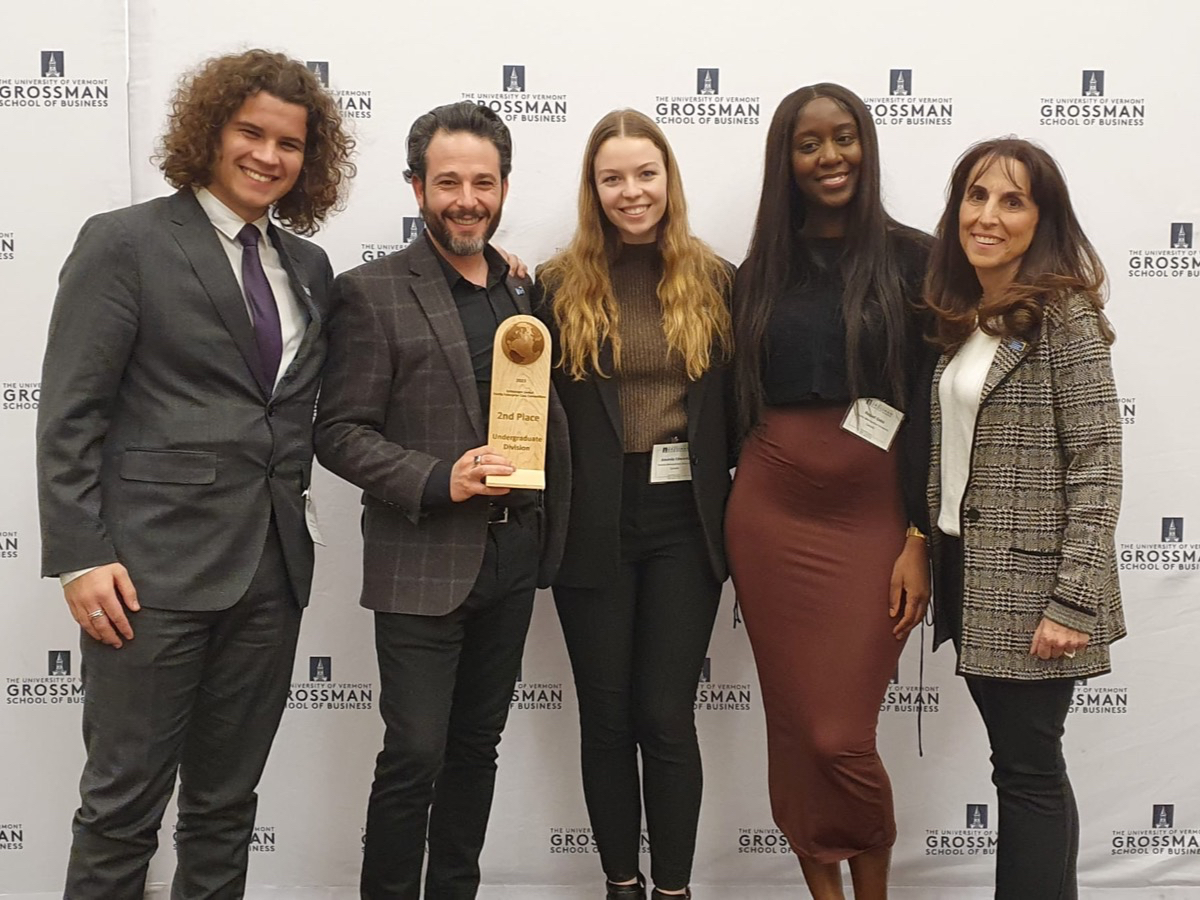 A team of students and faculty standing with their award at a competition