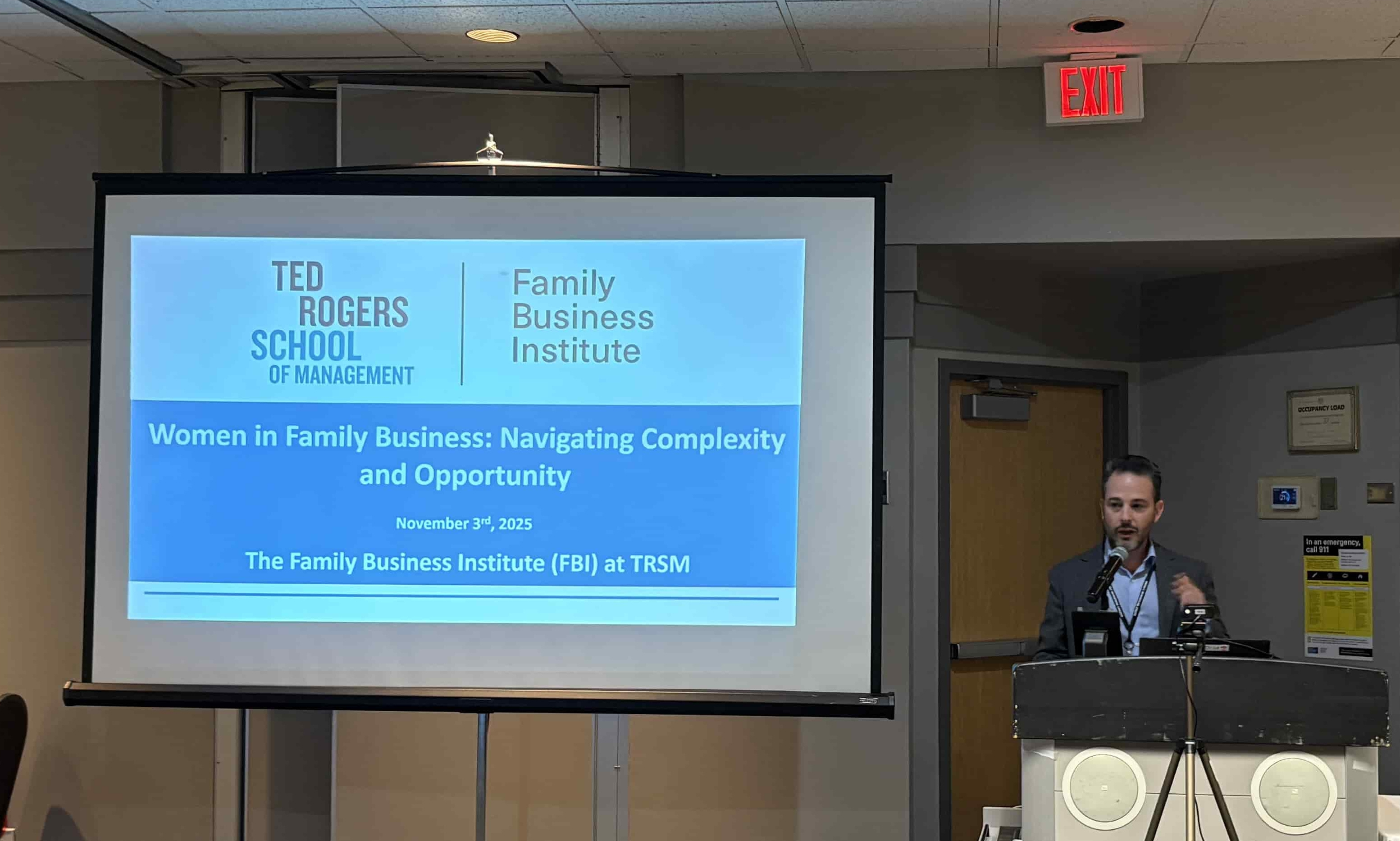 Francesco Barbera speaking at a podium beside a screen displaying the event title “Women in Family Business: Navigating Complexity and Opportunity.”