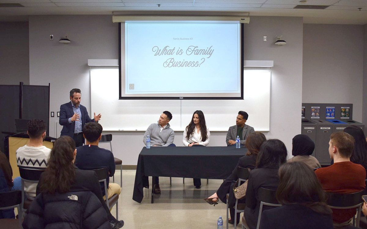 Professor Francesco Barbera speaking in front of a group at the FBSA event. He at the front of a classroom setting under a projection reading "Introduction to Family Business."