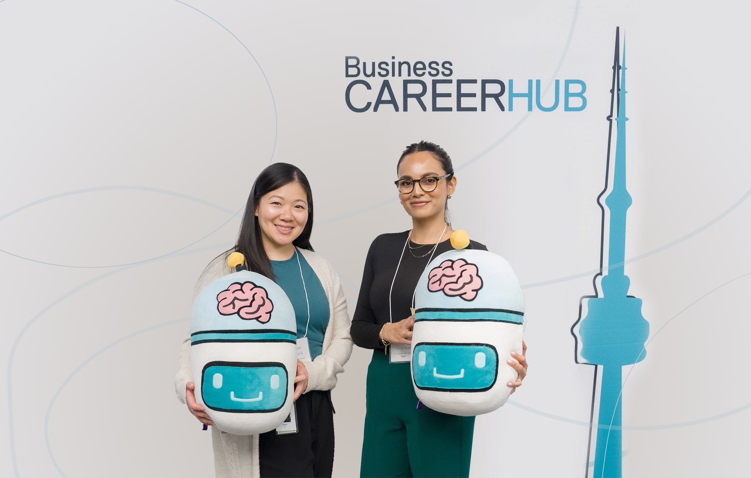 Students holding the stuffed Hubert bot at the Business Career Hub