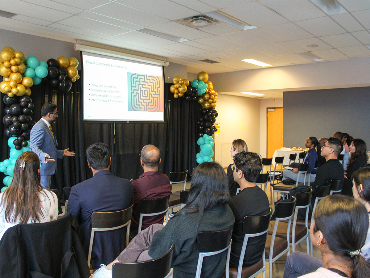 Winston Isaac Lecture event - attendees talking and attending presentation