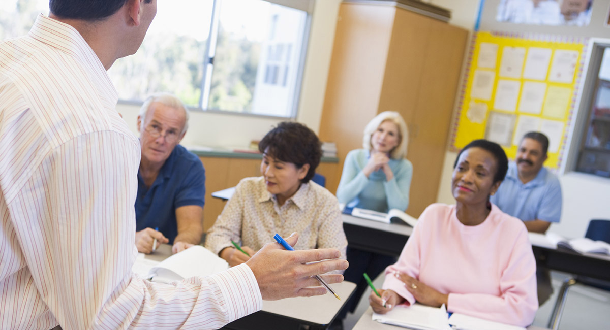 Students in a classroom listening to instructor