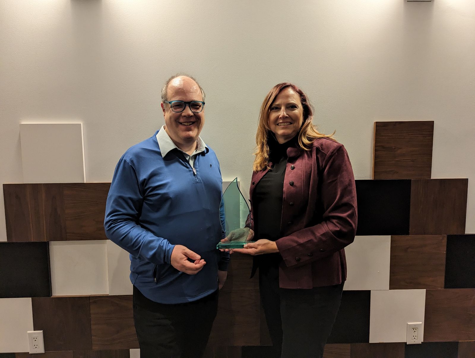 Beth Potter receiving the HTM Industry Award 2022-2023 from Interim Director, Dr. Wayne Smith.