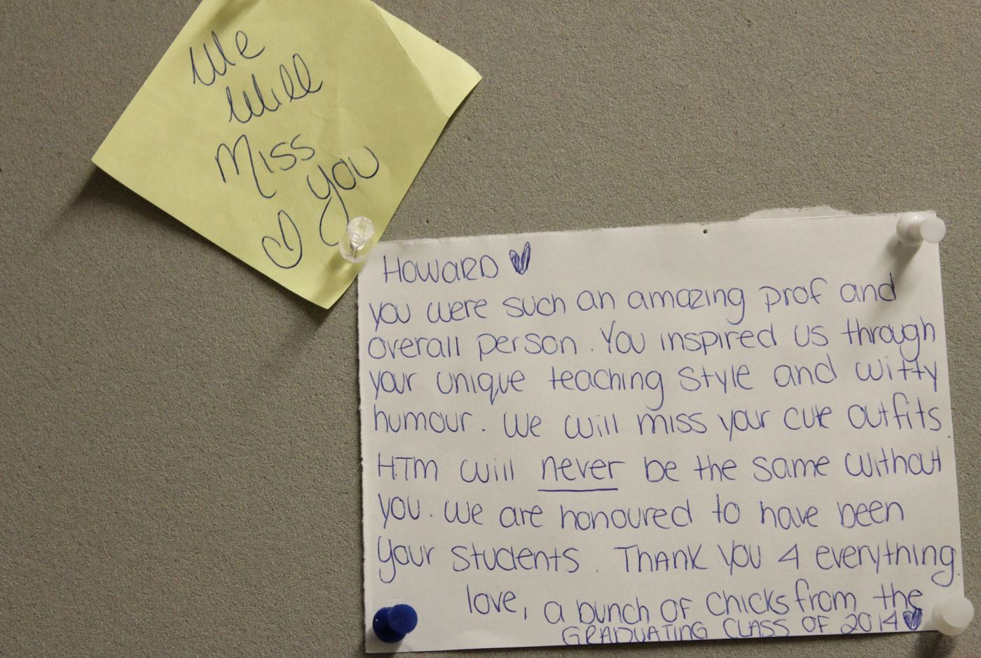 hand-written notes of thank you pinned on a board